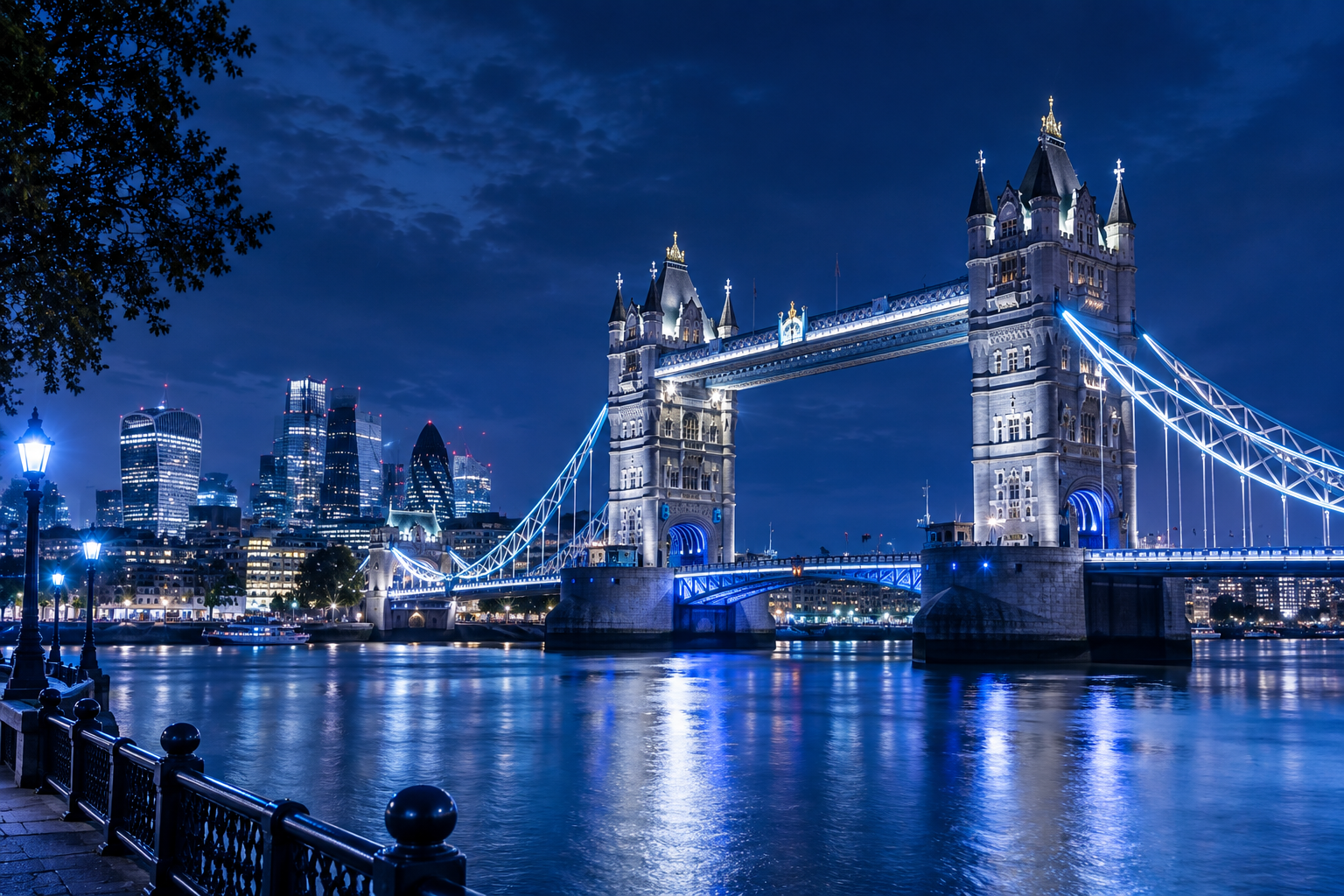 London skyline and Tower Bridge at night, representing UK business technology